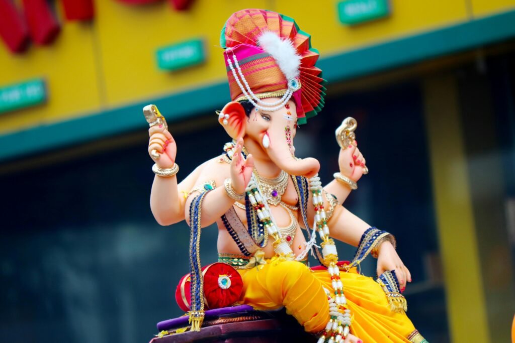 Colorful statue of Lord Ganesh during a festive outdoor celebration, rich in tradition and culture.