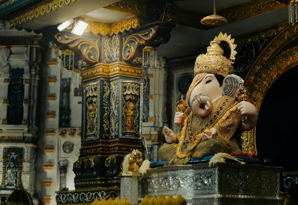 Intricately detailed Lord Ganesha statue in a richly decorated Indian temple, Pune, India.